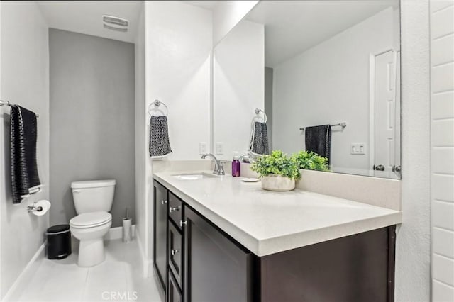 bathroom featuring toilet, visible vents, baseboards, vanity, and tile patterned floors