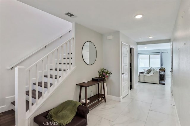 stairs with marble finish floor, baseboards, visible vents, and recessed lighting