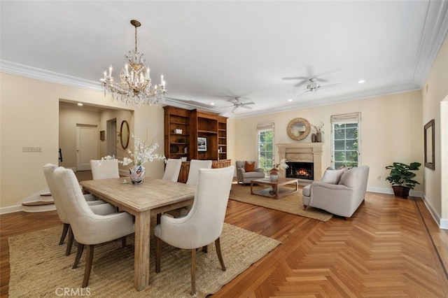 dining space with ornamental molding, a high end fireplace, and baseboards