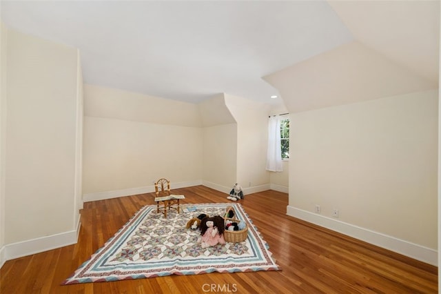 bonus room featuring lofted ceiling, baseboards, and wood finished floors