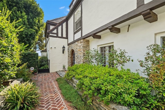 view of property exterior with stone siding and stucco siding