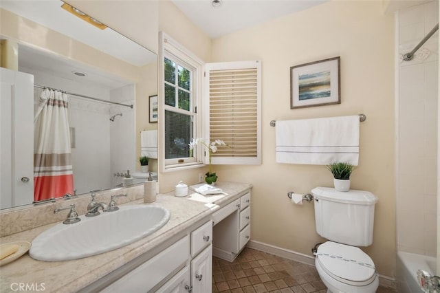 full bathroom featuring toilet, baseboards, and vanity