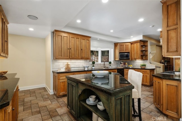 kitchen featuring decorative backsplash, stainless steel microwave, stone tile floors, and open shelves