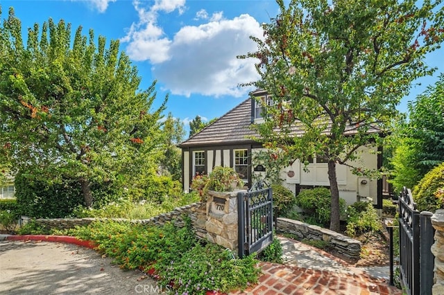 view of front facade with a gate and stucco siding