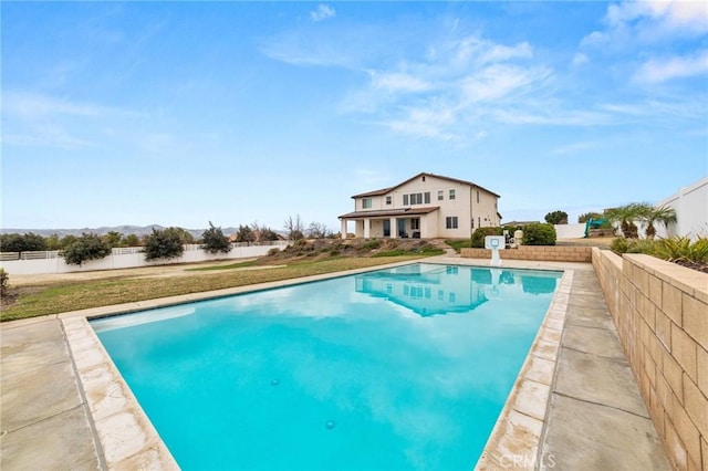 view of pool featuring a patio area, a fenced backyard, a fenced in pool, and a yard