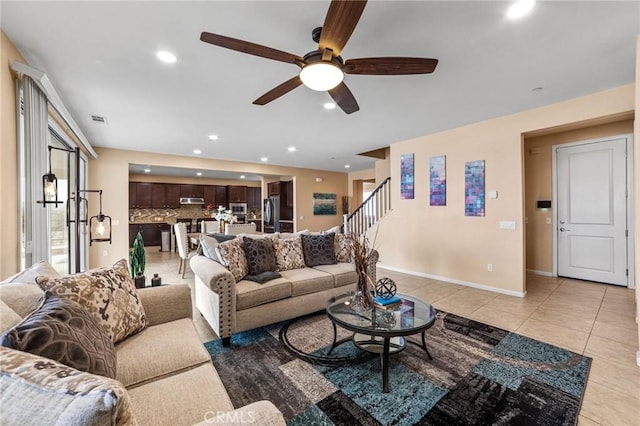 living room with light tile patterned floors, recessed lighting, visible vents, stairway, and baseboards