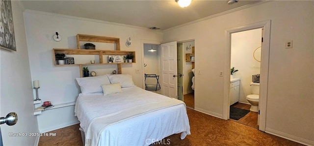 bedroom featuring ornamental molding, baseboards, visible vents, and ensuite bath