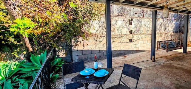 view of patio / terrace with outdoor dining area and fence