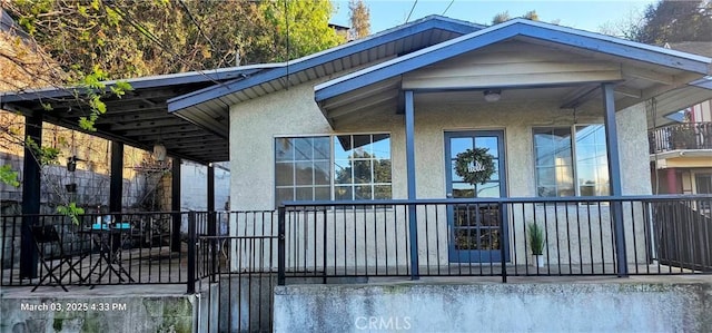 back of property featuring stucco siding