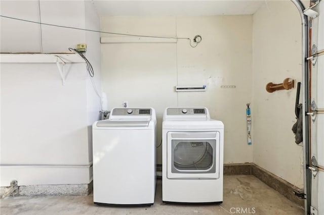 laundry room featuring washer and clothes dryer, laundry area, and baseboards