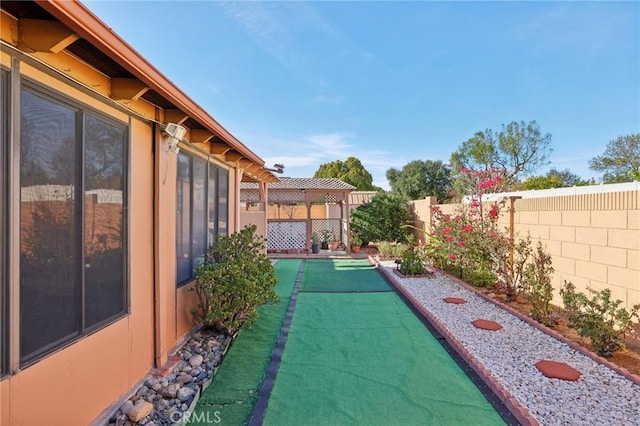 view of yard with a fenced backyard and a pergola