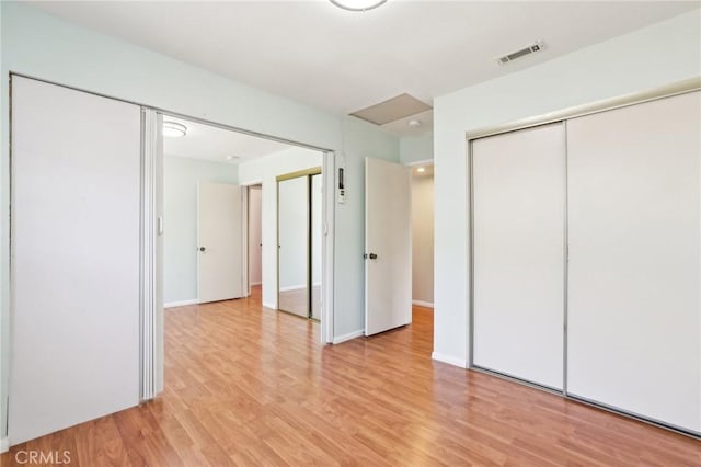 unfurnished bedroom featuring light wood-style floors, visible vents, and baseboards