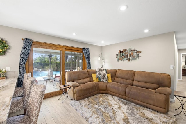 living area with recessed lighting and light wood finished floors