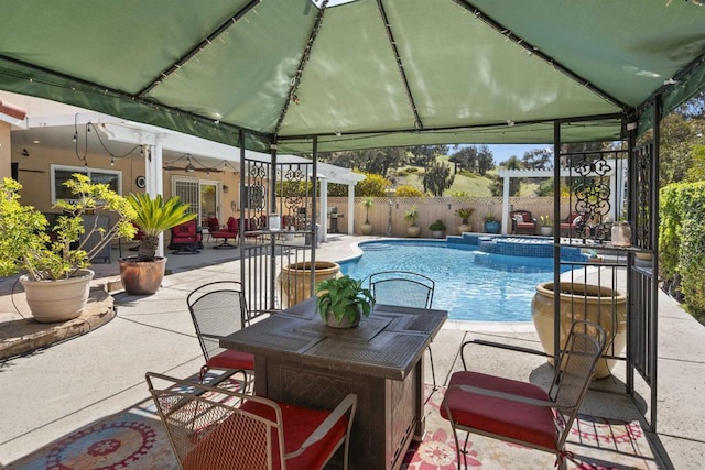 view of swimming pool featuring a gazebo, fence, a fenced in pool, and a patio