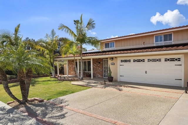 traditional-style home with an attached garage, stucco siding, concrete driveway, a front lawn, and roof mounted solar panels