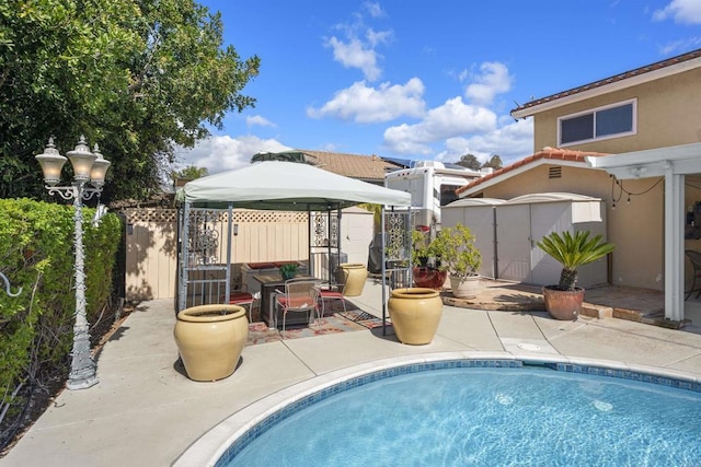 view of swimming pool featuring a patio area, a shed, a fenced in pool, and fence