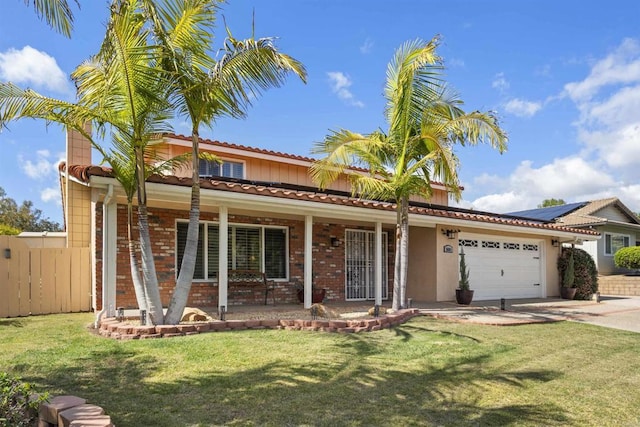 view of front facade with a garage, a porch, a front lawn, and fence