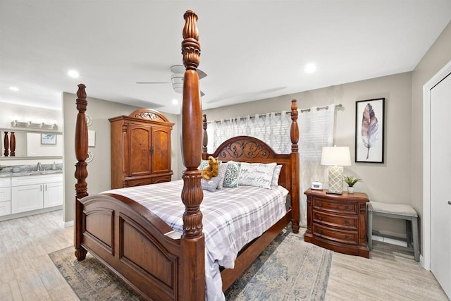 bedroom featuring recessed lighting, ensuite bathroom, and light wood finished floors