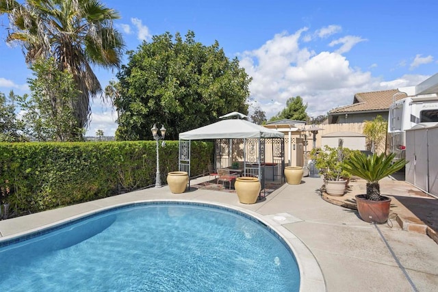 view of pool with a gazebo, a fenced in pool, a patio, and a fenced backyard