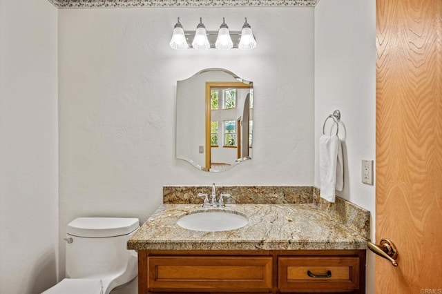 bathroom featuring toilet and vanity