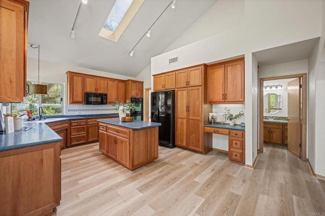 kitchen featuring dark countertops, black appliances, visible vents, and brown cabinets