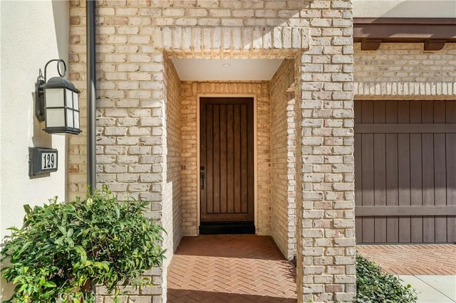 property entrance with brick siding