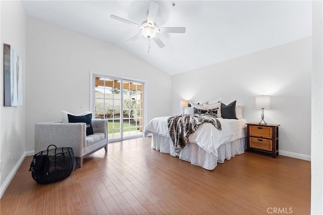 bedroom featuring lofted ceiling, access to outside, wood finished floors, and baseboards