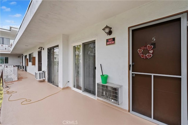 property entrance with stucco siding