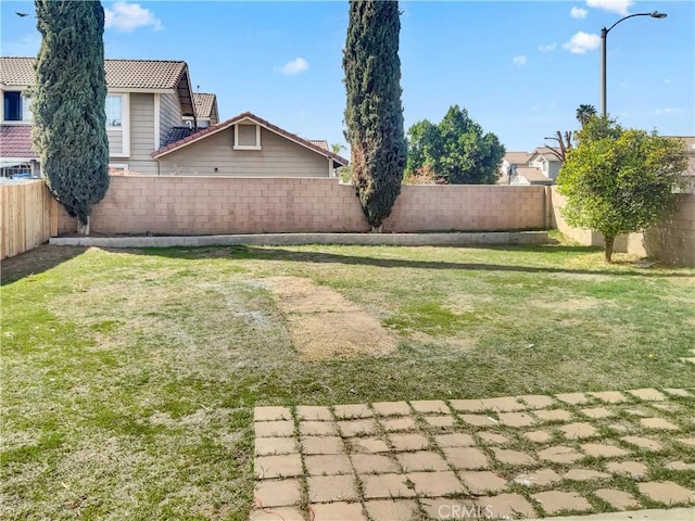 view of yard with a fenced backyard