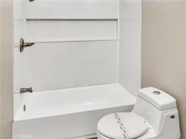 bathroom featuring a tub to relax in, walk in shower, and toilet