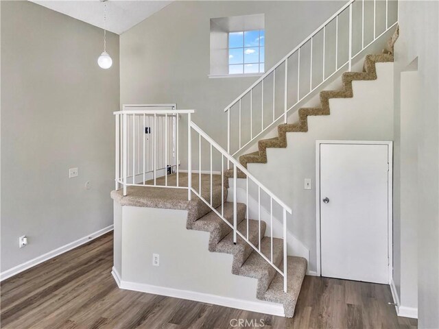 15279 Canyonstone Dr, Moreno Valley, CA 92551 - staircase with baseboards, wood finished floors, and a towering ceiling