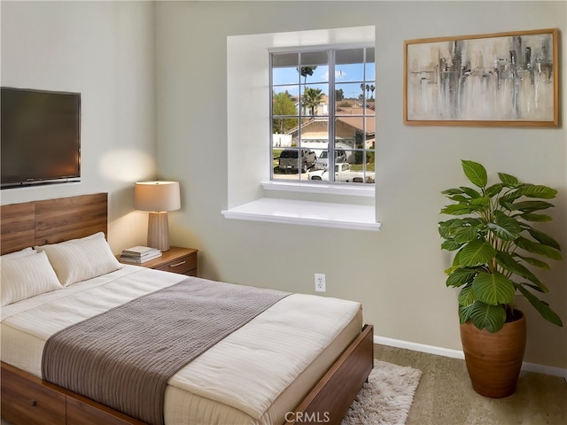 bedroom featuring carpet flooring and baseboards