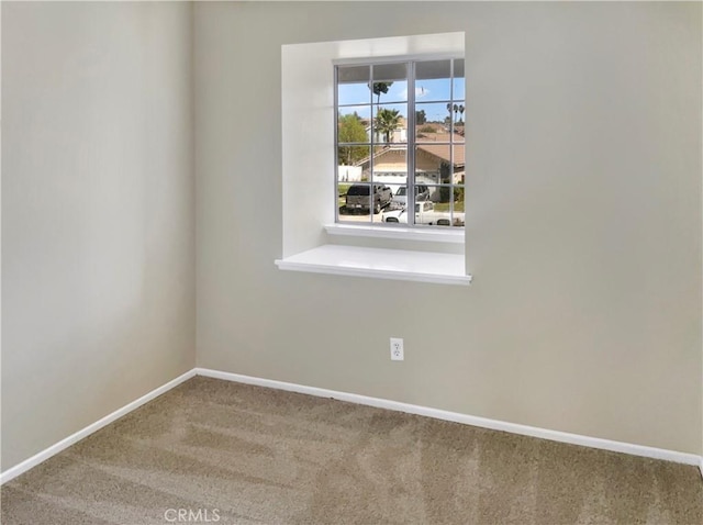 carpeted spare room with baseboards