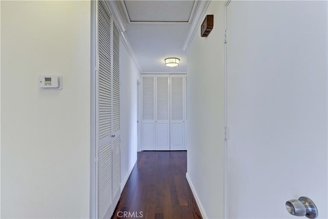 corridor with wood finished floors and baseboards