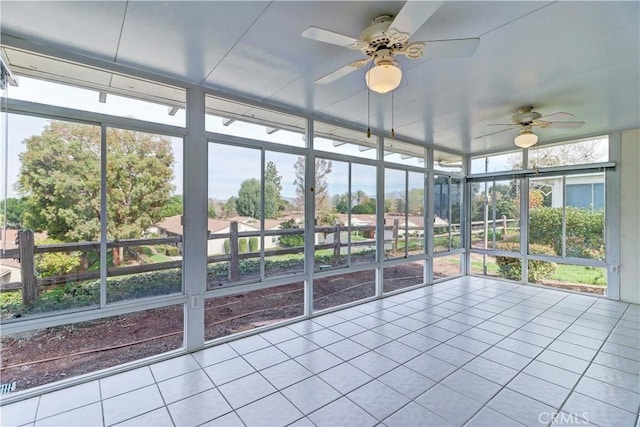 unfurnished sunroom featuring ceiling fan