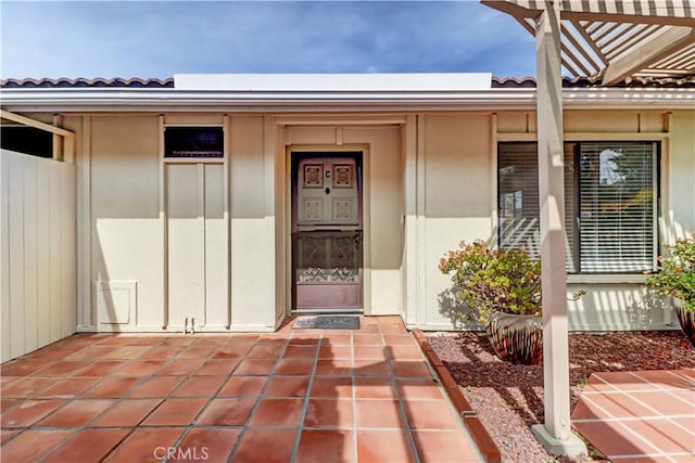 doorway to property with a tile roof