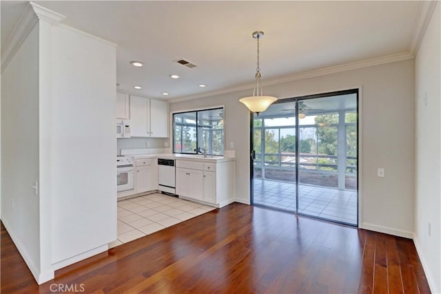 kitchen with range, dishwashing machine, white microwave, crown molding, and light wood-style floors