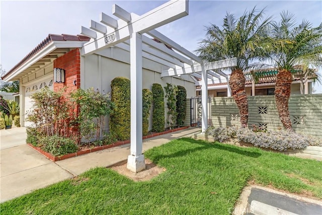 view of home's exterior with a garage, driveway, fence, a yard, and stucco siding