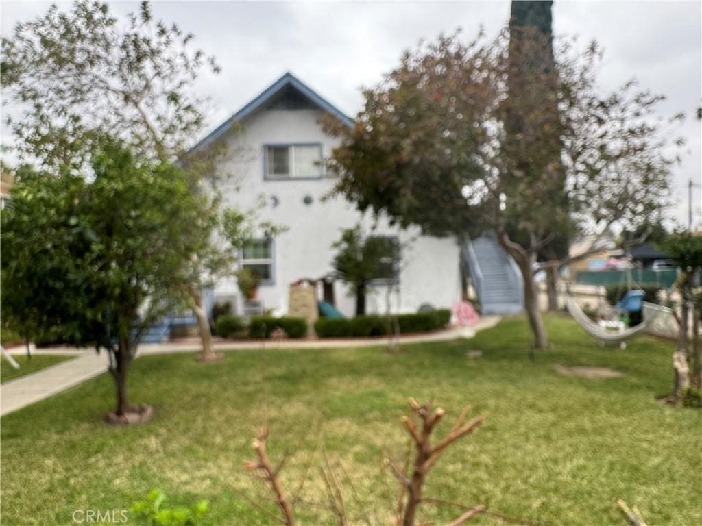 view of front of home featuring a chimney and a front lawn