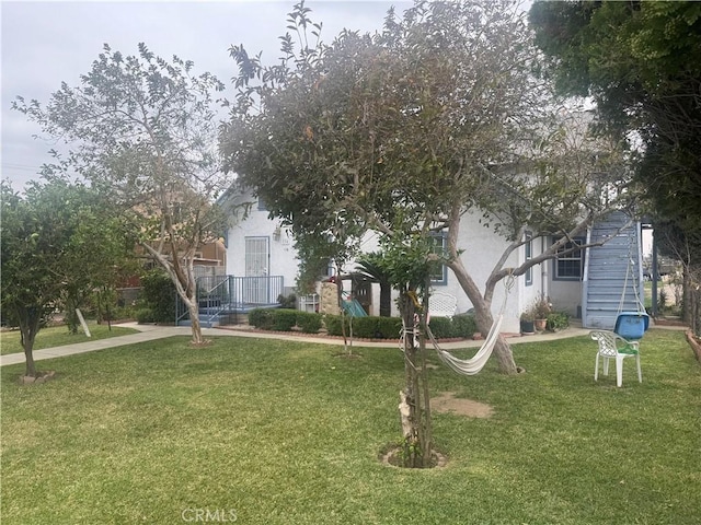 exterior space with a front yard and stucco siding