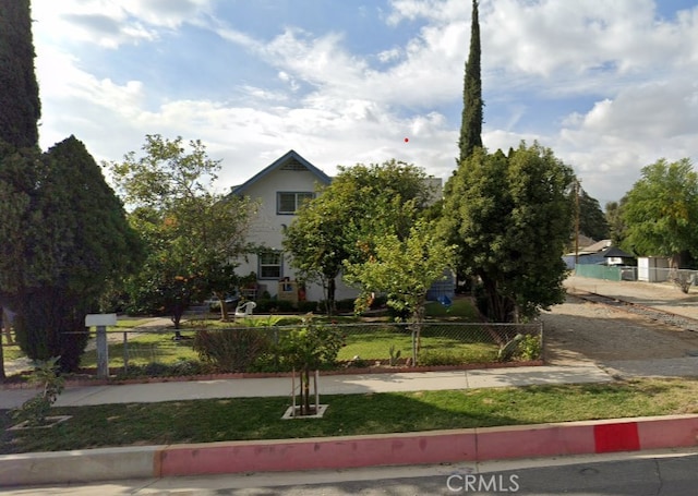 view of front of home with a fenced front yard and stucco siding