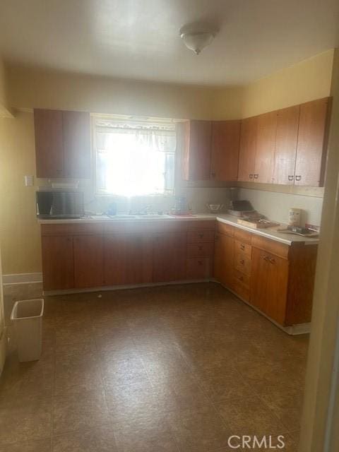 kitchen with light countertops and tile patterned floors