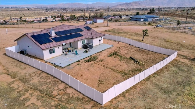 drone / aerial view featuring view of desert and a mountain view