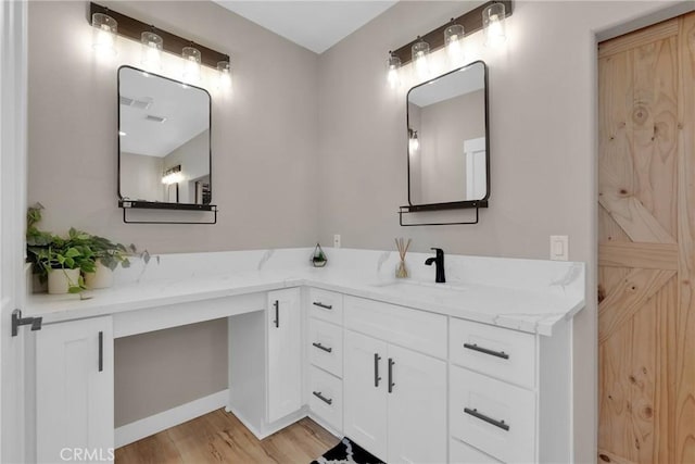 bathroom with wood finished floors and vanity