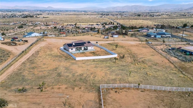 aerial view featuring a desert view, a rural view, and a mountain view