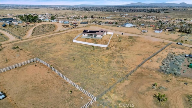 drone / aerial view featuring view of desert, a rural view, and a mountain view