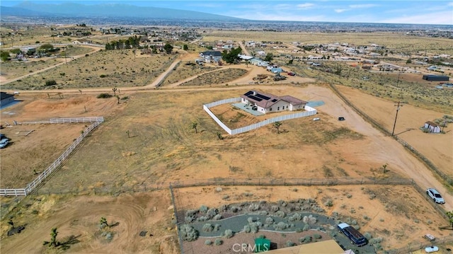 birds eye view of property with view of desert, a rural view, and a mountain view