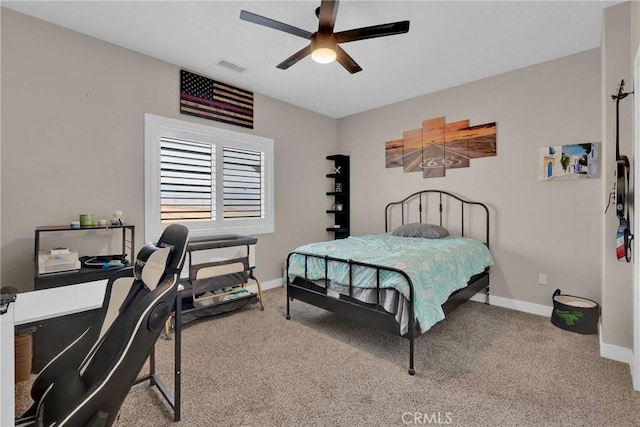 carpeted bedroom with visible vents, ceiling fan, and baseboards