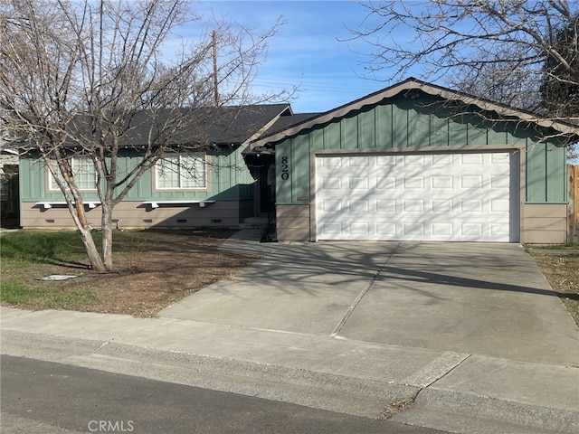 view of front of property with a garage, crawl space, and concrete driveway