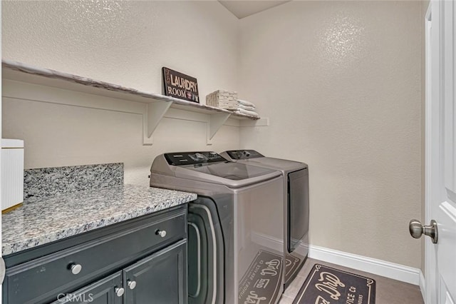 laundry area featuring cabinet space, washer and clothes dryer, and baseboards